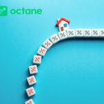 House model with percentage blocks representing falling mortgage rates