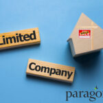 Wooden blocks reading “Limited Company” beside a house model with a sold sign, symbolising property investment.