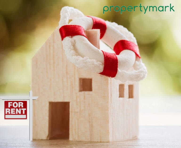 Wooden house model with life ring and for rent sign symbolising landlord support in rental market.