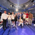 Group of participants and supporters posing in the boxing ring at Rumble with the Agents charity event