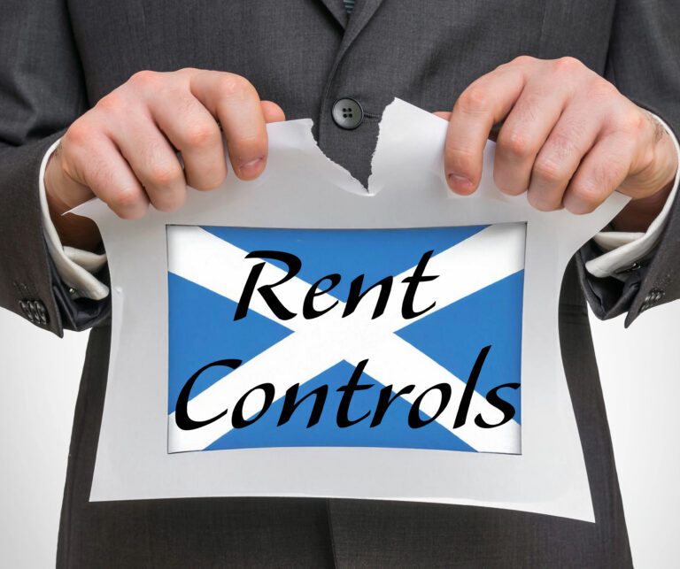 Businessman tearing paper with Scottish flag and words “Rent Controls”