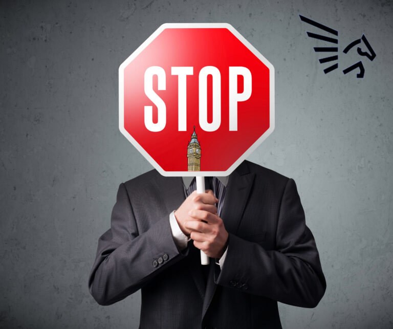 Businessman holding a stop sign highlighting calls to pause UK rental reforms