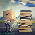 Woman carrying heavy tax burden up a ladder towards Scottish flag, symbolising landlord challenges