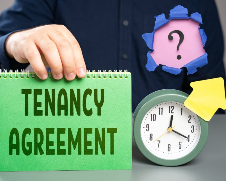 A person holding a calender saying tenancy agreement, a alarm clock, an arrow pointing upwards, and a question mark