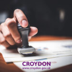 Croydon Council official stamping documents for housing regulation