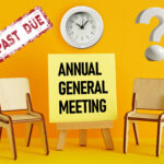 two chairs, annual general meeting, and past due sign, a clock and a question mark