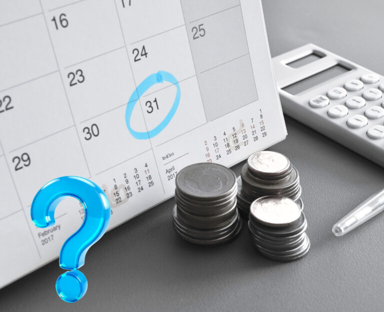 A calendar circuled on 31st of the month, a calculator, coins and a question mark