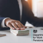 A man sitting at a desk with his hand on bank notes, Department for Work and Pensions logo