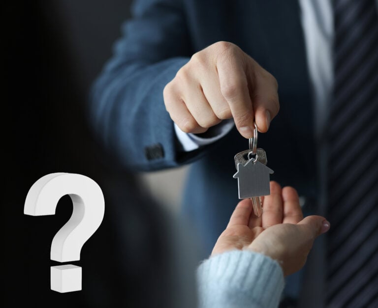 A person passing a key to a woman