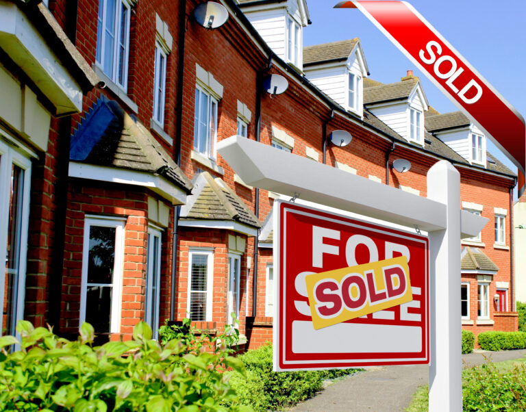 Row of modern brick houses with a ‘For Sale – Sold’ sign outside.