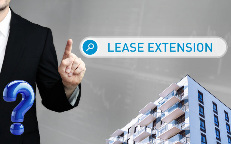 Person pointing at lease extension search with modern apartment building.