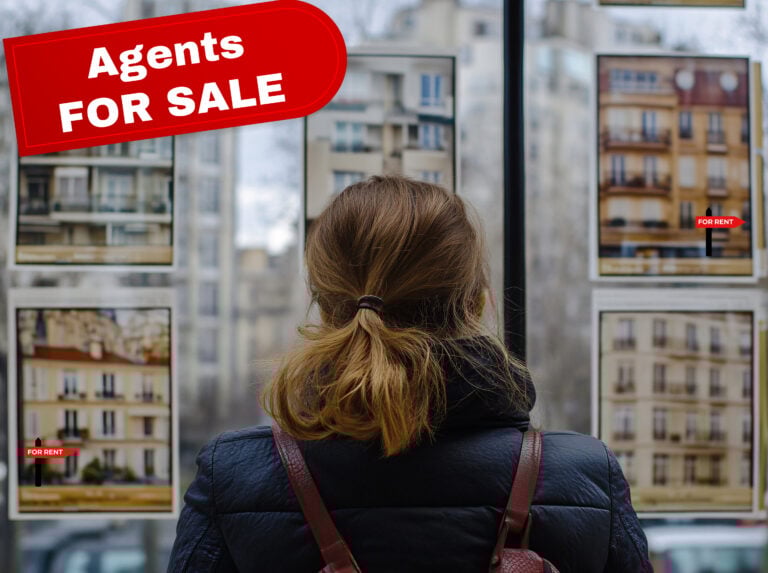 Woman looking at estate agent window with bold “Agents For Sale” sign.