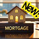 A wooden model house sitting on a wooden block, saying mortgage and New