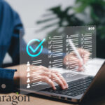 Hands typing on a laptop with a digital checklist overlay, representing Paragon’s new BTL mortgage platform.