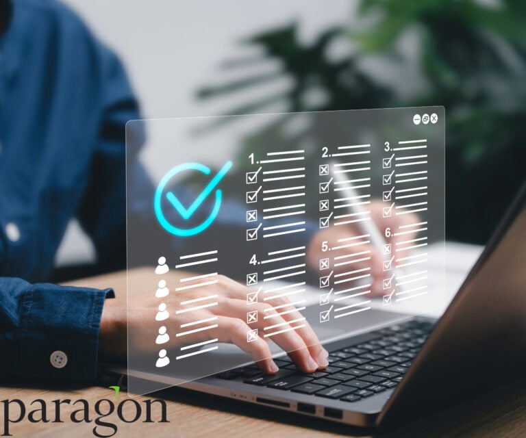 Hands typing on a laptop with a digital checklist overlay, representing Paragon’s new BTL mortgage platform.