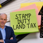 A picture of Phil Spencer, sticky notes Stamp Duty Land Tax, an arrow pointing upwads and a warning triangle sign