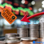 Coins stacked with a house, red downward arrow, and “Price Reduced” tag showing UK property market cuts.