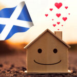 Scottish flag, a wooden house with a face smiling and hearts floating our of the chimley