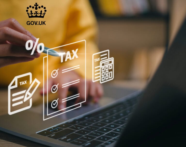 A person writing on a digital screen of a laptop showing Tax and a percentage sign, Gov.uk logo