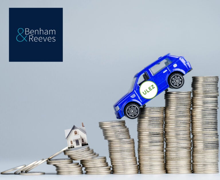A blue car balancing on stacked coins