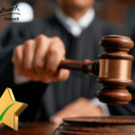 A judge using a justice hammer and star with a green tick