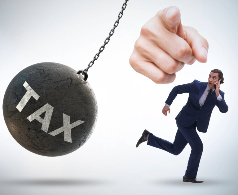 A person running, a finger pointing, and Tax written on a demolition wrecking ball