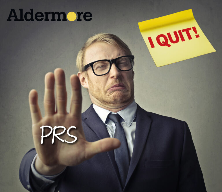 A man with his hand up in front of him, PRS and I quit on a post it note,