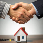 People shaking hands on top of a small house