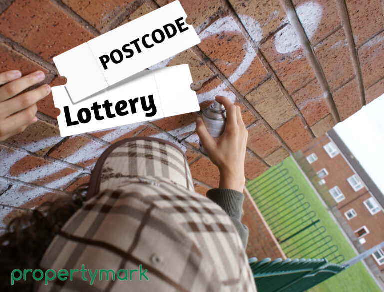 A person doing graffiti on a wall, in a housing estate and postcode lottery text