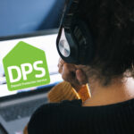 Deposit Protection Service on a laptop with a women sitting at a desk