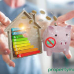 A person holding a EPC graph within a wooden house outline