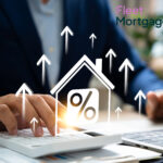 A businessman working on a laptop and a calculator, a digital image shape of a house with a percentage sign and arrows pointing upwards