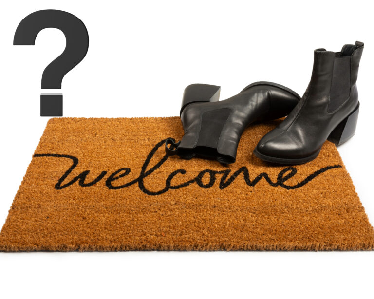 A welcome mat with boots and a question mark
