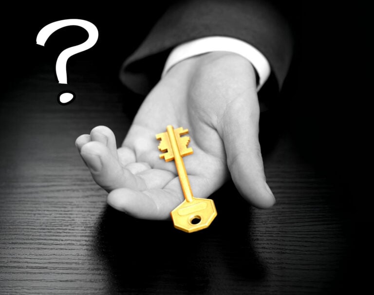 A black and white image of a person holding a gold key and a question mark
