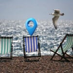 Deck chairs on a back with a location pin and a seagul