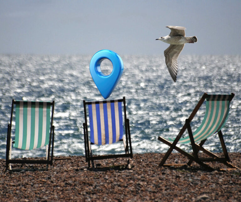 Deck chairs on a back with a location pin and a seagul