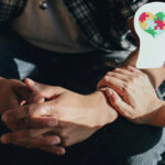 A person touching another person arm in a caring way and an image on the mind