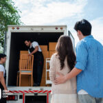 A couple standing in front of a moving truck