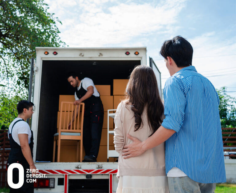 A couple standing in front of a moving truck