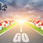 a model street of houses either side and a GO sign with a sunset in the background