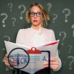 A womena holding a tenancy agreeemnt and questions marks in the background