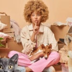 A tenant surrounded by boxes and pets