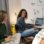 Two students in student accommodation and UK bank notes