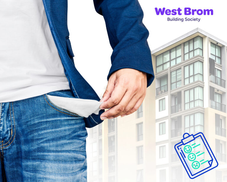 A person showing an empty pocket with a building in the background