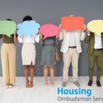 People holding bubble cards and Housing Ombudsman