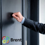 Businessman knocking a black door