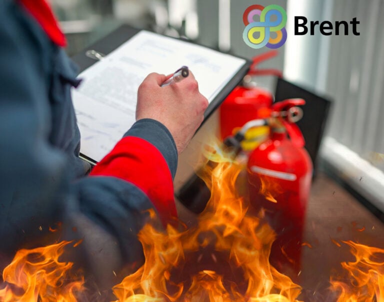 A person writing on a clipboard surrounded by flames and a fire extinguisher