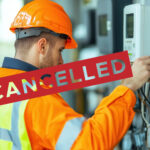 A person with a safety vest on with a safety orange helmet working on a smart meter and the word cancelled