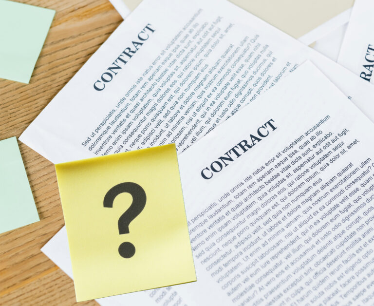 Contract papers with a question mark sticky note symbolizing tenancy agreement uncertainty.