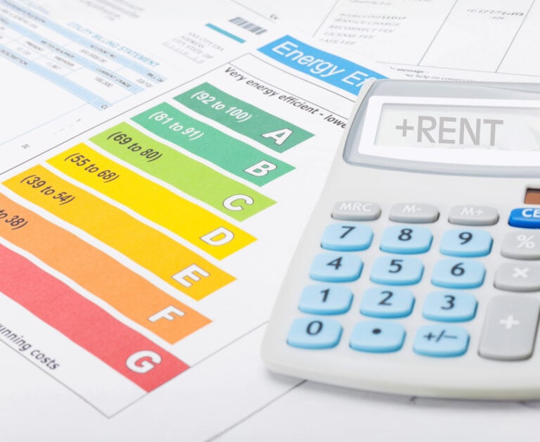 Calculator saying rent and EPC report on a desk with bills